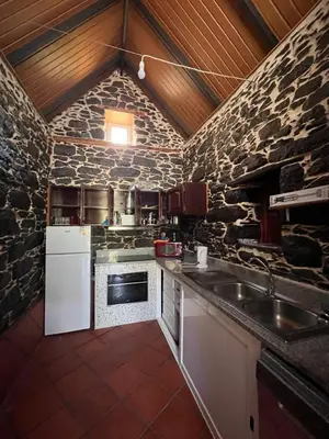 a stone kitchen with a sink and a stove at Casa Duque - In the Heart of Santana Mountains in Santana