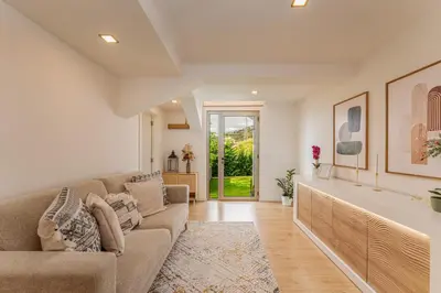 a living room with a couch and a table at The Viewpoint by Eurostay in Ribeira Brava
