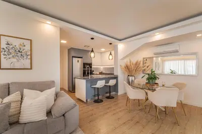 a living room with a couch and a table at The Viewpoint by Eurostay in Ribeira Brava
