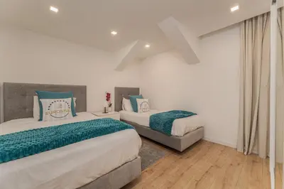 a bedroom with two beds and a window at The Viewpoint by Eurostay in Ribeira Brava