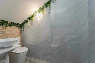 a bathroom with a toilet and a glass shower at The Viewpoint by Eurostay in Ribeira Brava