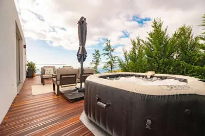 a hot tub on the deck of a house at The Viewpoint by Eurostay in Ribeira Brava