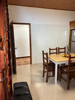 a dining room with a table and chairs at Casa estrelicia II in Relógio do Poiso