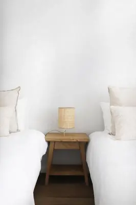 two twin beds with a table with a lamp on it at B View Madeira - Ocean & Bay View Apartment in Câmara de Lobos