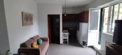 a living room with a couch and a kitchen at Ape T0 in São Vicente
