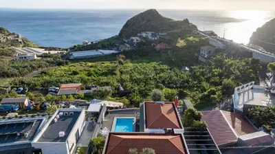 an aerial view of a resort with the ocean at Oceanfront Villa with Private Pool Breathtaking Sunsets in Madeira in Tábua