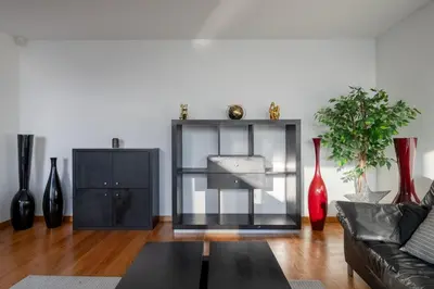 a living room with a black couch and vases at Oceanfront Villa with Private Pool Breathtaking Sunsets in Madeira in Tábua