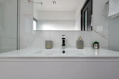 a bathroom sink with two soap bottles on it at Oceanfront Villa with Private Pool Breathtaking Sunsets in Madeira in Tábua