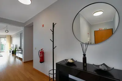 a mirror on top of a dresser in a living room at Anchored in Carmo by Homie in Câmara de Lobos