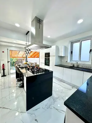 a kitchen with a black and white counter top at O Cantinho do Zé - Signature Funchal in Funchal