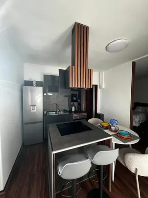 a kitchen with a counter and some chairs in a room at Casa de férias Funchal in Nossa Senhora do Monte