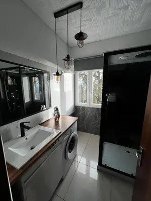 a bathroom with a sink and a washing machine at Casa de férias Funchal in Nossa Senhora do Monte
