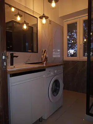 a bathroom with a washing machine and a sink at Casa de férias Funchal in Nossa Senhora do Monte