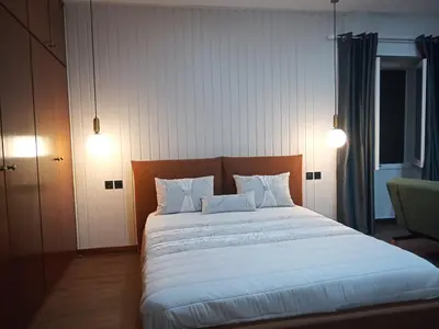 a bedroom with a large bed with white sheets and pillows at Casa de férias Funchal in Nossa Senhora do Monte