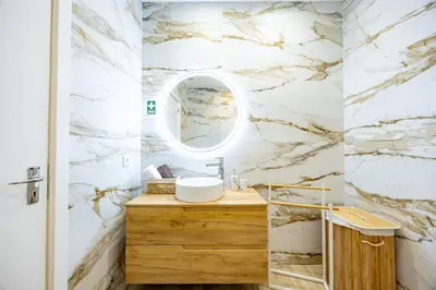 a bathroom with a sink and a mirror at Vivenda Paz Lobo by YOUR KEY MADEIRA in Gaula