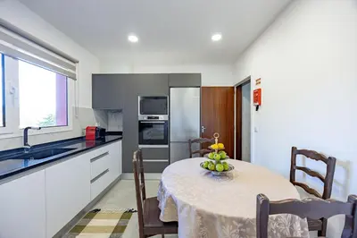 a kitchen with a table with a bowl of fruit on it at Vivenda Paz Lobo by YOUR KEY MADEIRA in Gaula
