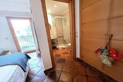 a bedroom with a door open to a bathroom at SV Villa Burgau in Burgau