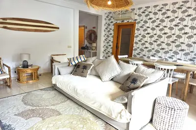 a living room with a white couch and a table at SV Villa Burgau in Burgau