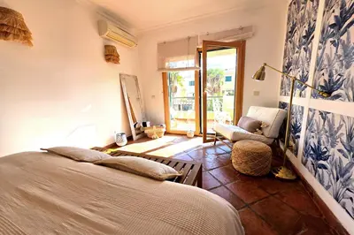 a bedroom with a bed and a chair in a room at SV Villa Burgau in Burgau