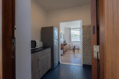 a kitchen with a refrigerator and a dining room at Apartamento Navio Azul in Funchal