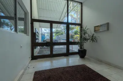 a room with a large window and a potted plant at Apartamento Navio Azul in Funchal