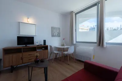 a living room with a tv and a table at Apartamento Navio Azul in Funchal
