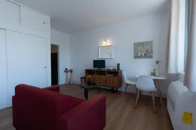 a living room with a red couch and a table at Apartamento Navio Azul in Funchal