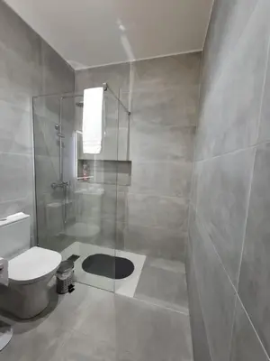a bathroom with a shower and a toilet at Rosolamar Villa with Ocean View in Câmara de Lobos