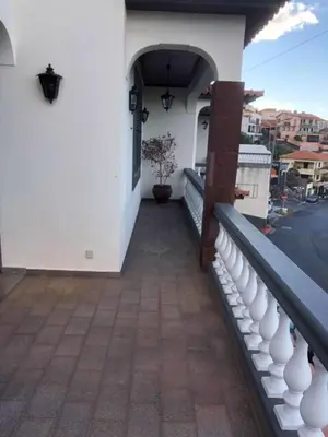 a toilet with its seat up in a bathroom at Rosolamar Villa with Ocean View in Câmara de Lobos