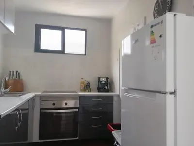 a kitchen with a white refrigerator and a stove at Yellow owl in Campanário