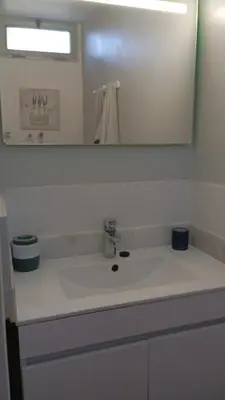 a bathroom with a white sink and a mirror at Yellow owl in Campanário