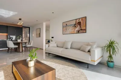 a living room with a couch and a table at BHF Residences Luxe Family in Arco da Calheta