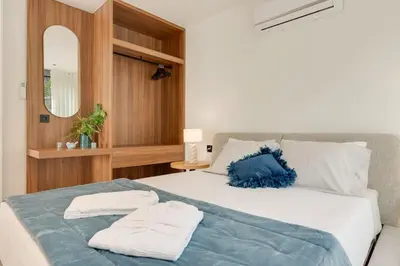 a bedroom with a bed with two towels on it at BHF Residences Luxe Family in Arco da Calheta