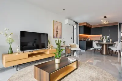a living room with a large flat screen tv at BHF Residences Luxe Family in Arco da Calheta