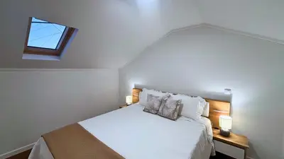 a bedroom with a white bed with a window at Sophia House By Sam Houses in Canhas