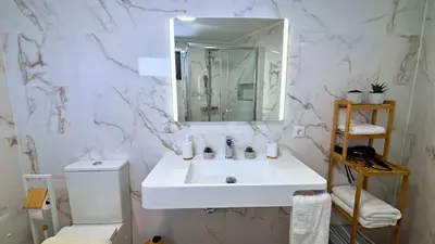 a white bathroom with a sink and a mirror at Sophia House By Sam Houses in Canhas