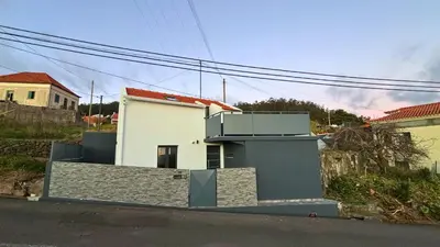 a white house with a gate in front of it at Sophia House By Sam Houses in Canhas