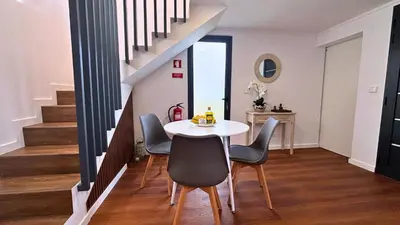 a dining room with a table and chairs at Sophia House By Sam Houses in Canhas
