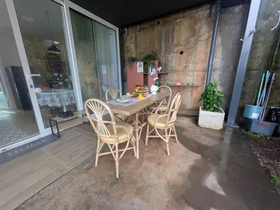a wooden table and chairs on a patio at CasAmor - Romantic Ocean View Studio in Santa Cruz