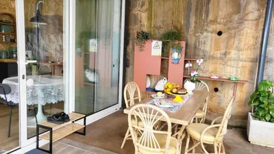 a table and chairs on a balcony with a table at CasAmor - Romantic Ocean View Studio in Santa Cruz