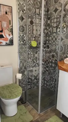 a bathroom with a shower with a toilet at Personal blue house Madeira in Santa Cruz