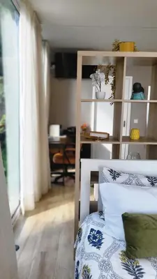 a living room with a chair and a room with a table at Personal blue house Madeira in Santa Cruz