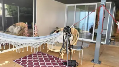 a camera on a tripod in a room with a hammock at Personal blue house Madeira in Santa Cruz