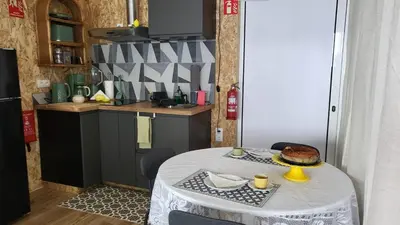 a kitchen with a table with a cake on it at Personal blue house Madeira in Santa Cruz