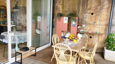 a table and chairs on a porch with a table at Personal blue house Madeira in Santa Cruz