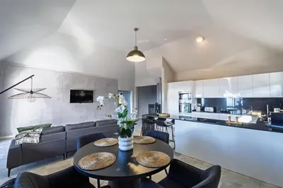 a living room and kitchen with a table and chairs at Passaras - countryside retreat in west of island in Ponta do Pargo