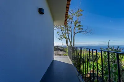 a balcony with a view of the ocean at Passaras - countryside retreat in west of island in Ponta do Pargo