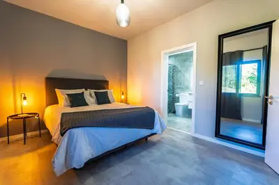 a bedroom with a bed and a large mirror at Passaras - countryside retreat in west of island in Ponta do Pargo