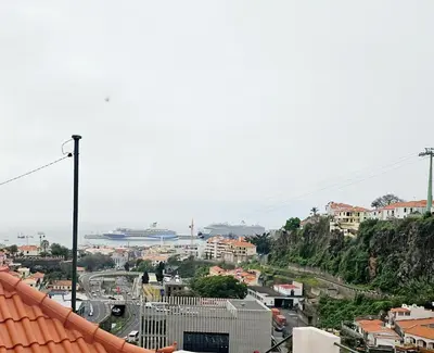 a view of a city from the roof of a building at Funchal Pink Hostel in Funchal