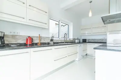 a white kitchen with white cabinets and appliances at Villa Valentina by Atlantic Holiday in Ponta do Sol
